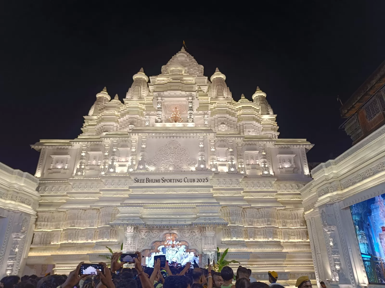 Crowd enjoying Durga Puja celebration in Kolkata with lights and colors