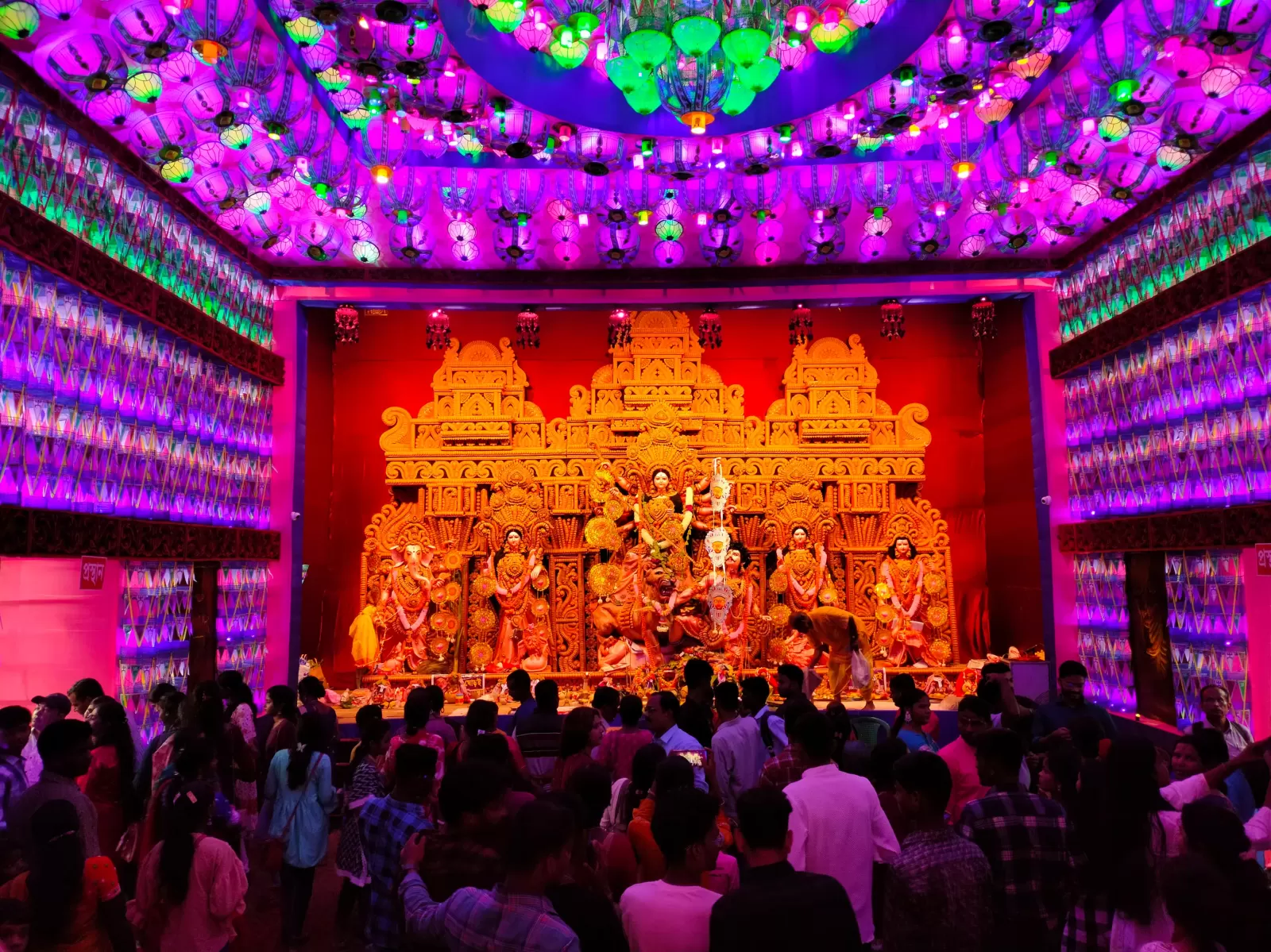 A festive Dasra moment as a family creates a bright rangoli design with flower petals and colored powders, marking Vijayadashami 2025 traditions.